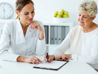 doctor and senior woman having a signing contract