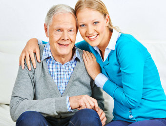 female caregiver and senior man are smiling