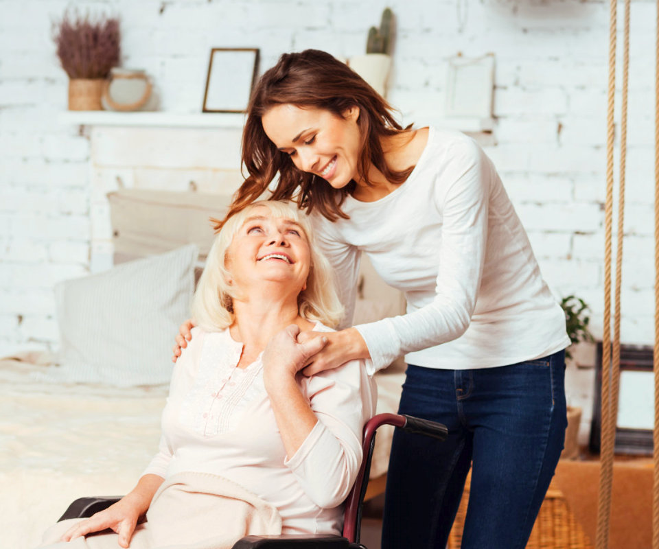 caregiver and senior woman are laughing